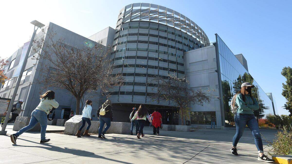 Students and visitors come and go at the Fresno State Library.